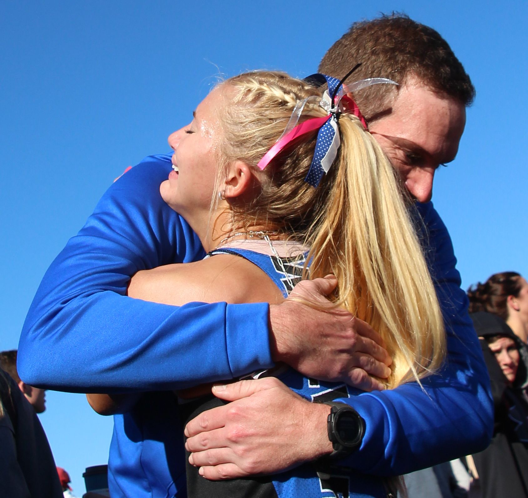 D-NH head coach Will Reingardt hugs Taylor Kvale after the senior&#039;s final cross country race in Fort Dodge at the 2021 state meet. Kvale was a three-time state medalist. (Jake Ryder photo)